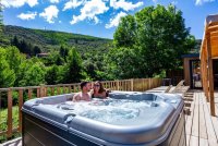 cottage_premium_gorges_heric_spa_jaccuzi_terrasse_bord_riviere © Camping Les Cerisiers du Jaur****